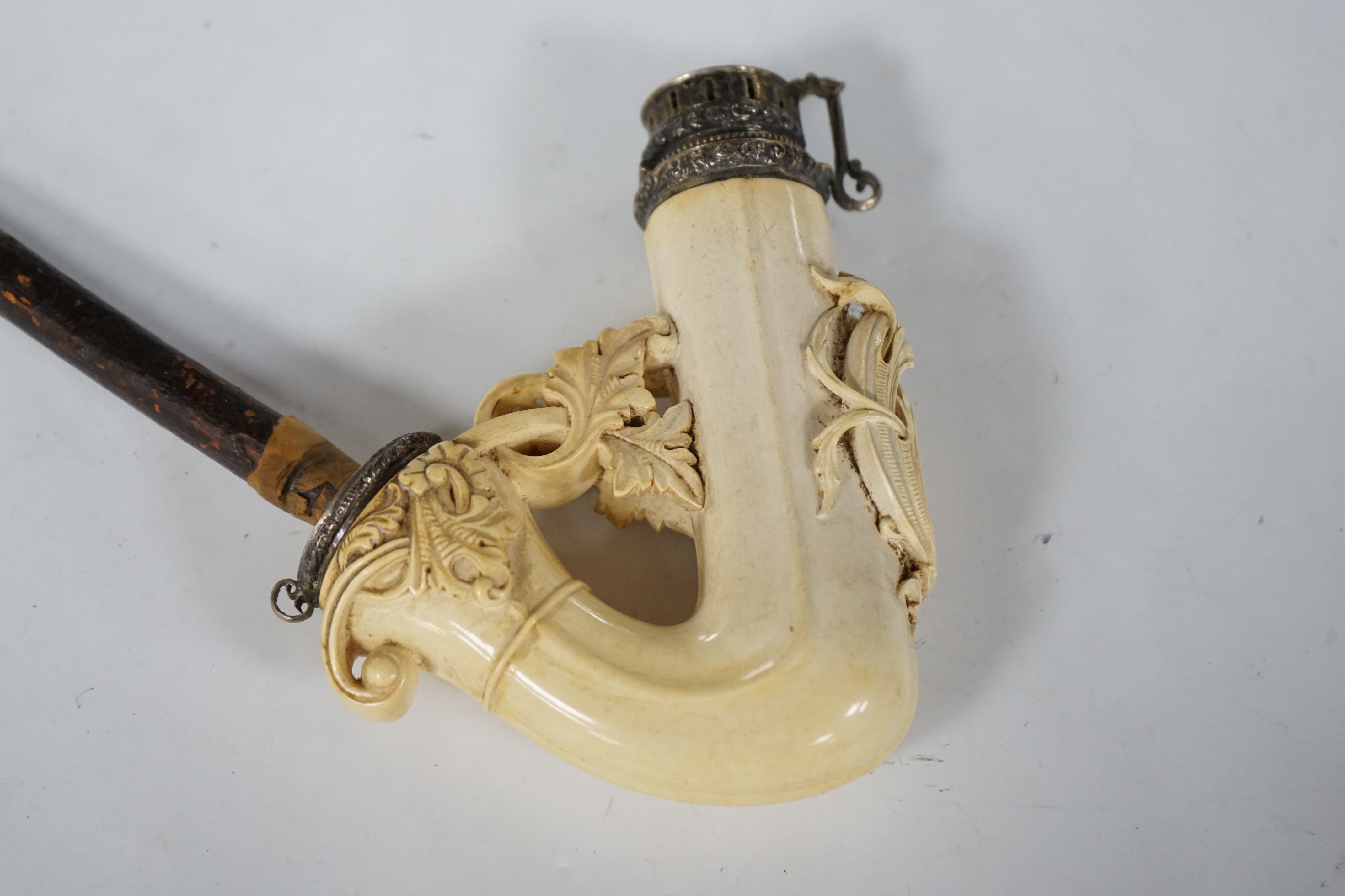 An ornate Meerschaum pipe, with carved monogram on the bowl and metal cover, 30cm long
